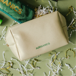 Gold cosmetic bag skincare travel pouch with green 'AURGANICS' branding: Aurganics Skincare for melanated glowgetters with sensitive skin