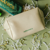 Gold cosmetic bag skincare travel pouch with green 'AURGANICS' branding: Aurganics Skincare for melanated glowgetters with sensitive skin