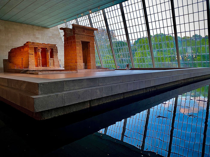 Reconstructed ancient temple model in a modern setting with large windows.