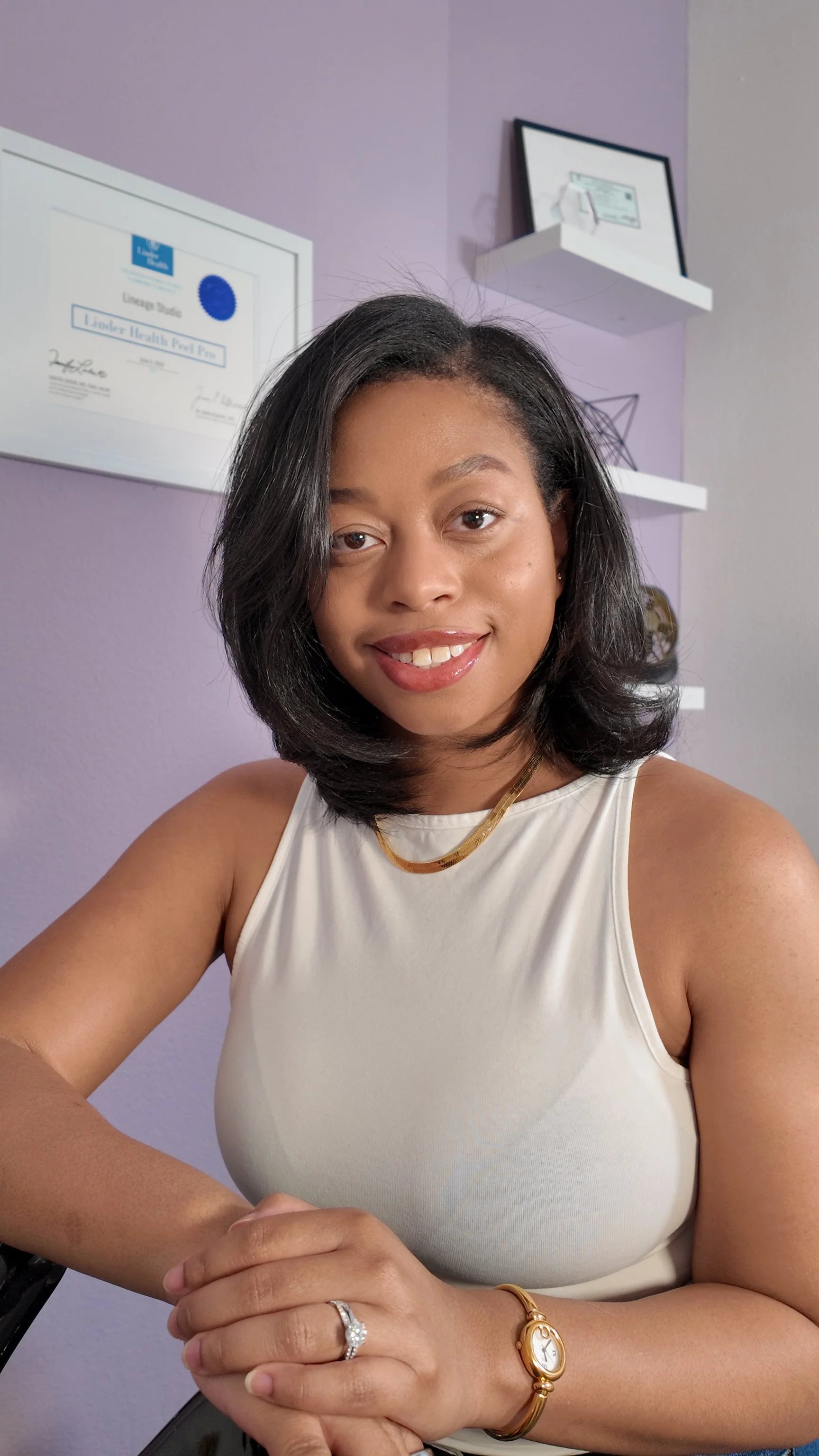 Woman sitting in an office setting with certificates on the wall